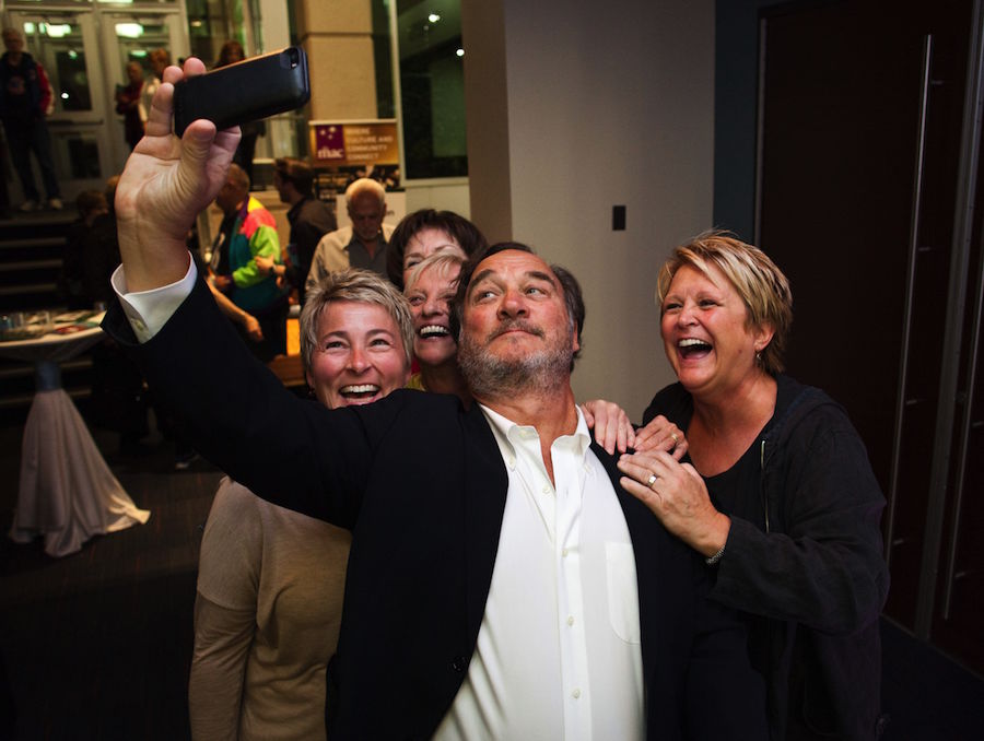 Jim Belushi poses for selfies with fans in the MAC lobby following the dedication.